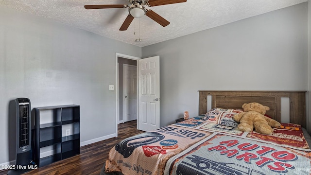 bedroom with dark wood-type flooring, baseboards, a textured ceiling, and heating unit