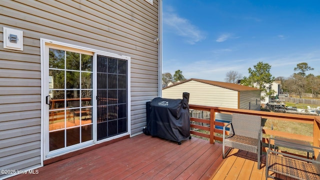 wooden deck with a grill