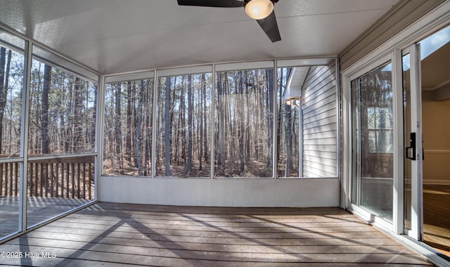 unfurnished sunroom with ceiling fan