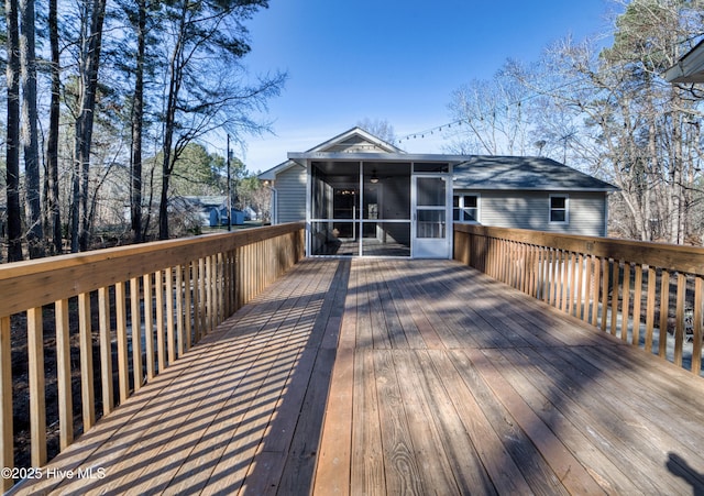 wooden deck with a sunroom