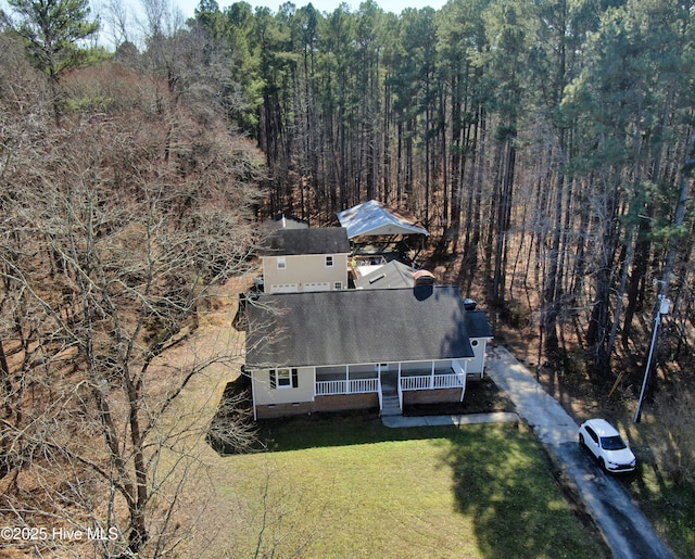 bird's eye view with a wooded view