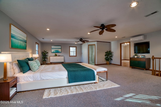 bedroom featuring carpet, a wall unit AC, recessed lighting, visible vents, and baseboards