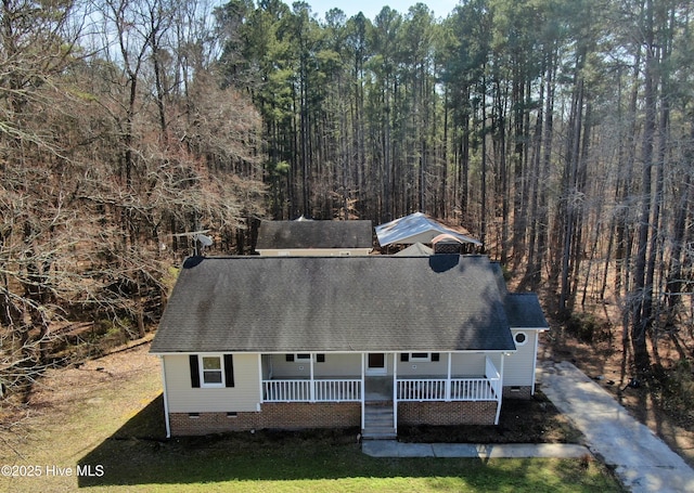 view of front of property with a porch, crawl space, and a shingled roof