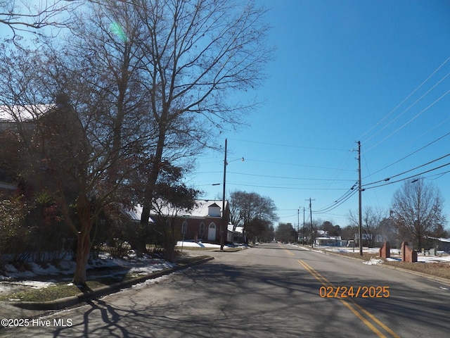 view of street with sidewalks, street lighting, and curbs