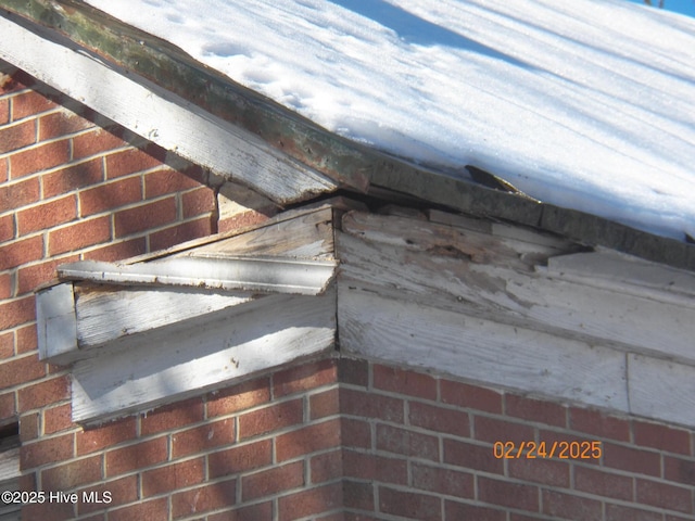 exterior details featuring brick siding