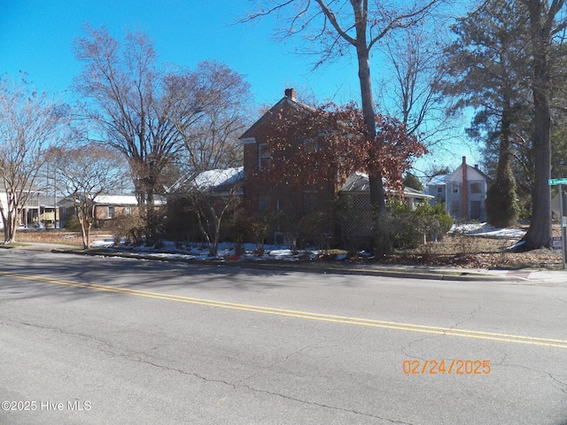 view of road featuring a residential view, curbs, and sidewalks