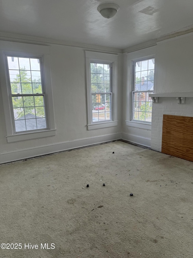 empty room featuring light carpet and baseboards