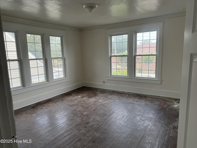 unfurnished room featuring dark wood finished floors and baseboards