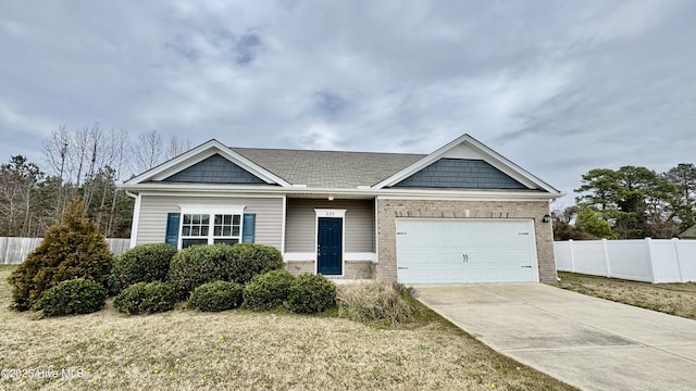 view of front of house with fence, driveway, an attached garage, a front lawn, and brick siding