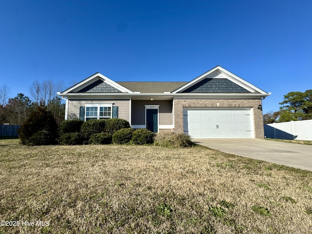 view of front of house featuring driveway, a front lawn, an attached garage, and fence