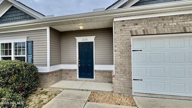 view of exterior entry with a garage