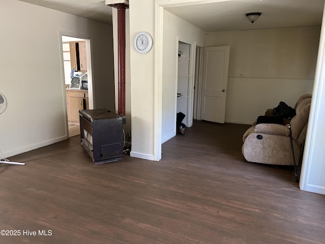 corridor with dark wood finished floors and baseboards