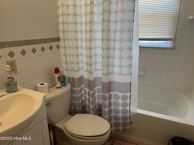 full bathroom with shower / tub combo with curtain, tile walls, toilet, and vanity