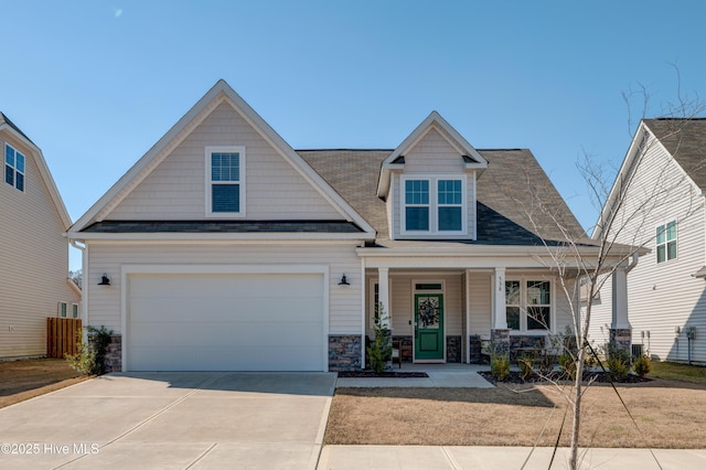 craftsman inspired home with stone siding, concrete driveway, covered porch, and an attached garage