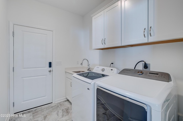 laundry room featuring marble finish floor, separate washer and dryer, a sink, and cabinet space