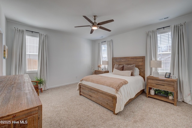 bedroom featuring a ceiling fan, light colored carpet, visible vents, and baseboards