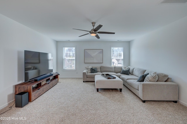 carpeted living area with plenty of natural light, visible vents, baseboards, and ceiling fan