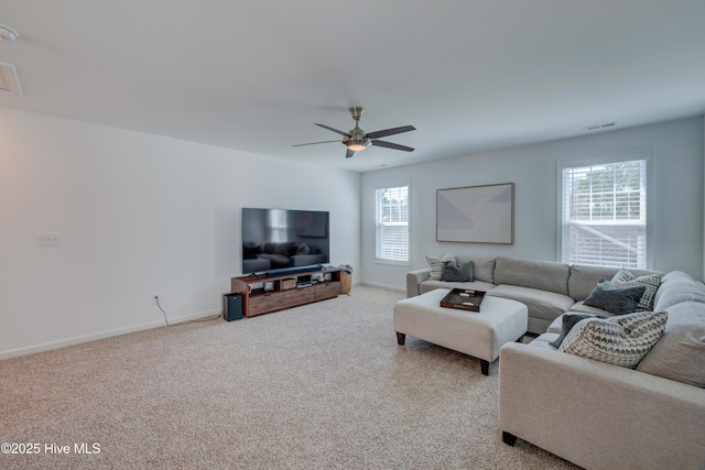 carpeted living area featuring baseboards, visible vents, and ceiling fan