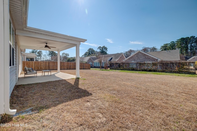 view of yard featuring ceiling fan, a patio area, and fence