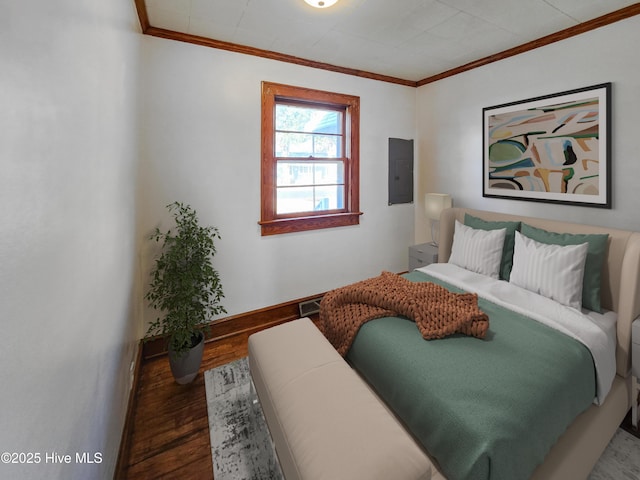 bedroom featuring electric panel, baseboards, visible vents, ornamental molding, and wood finished floors