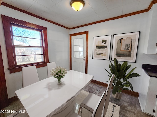 dining area with ornamental molding and baseboards