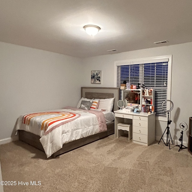 bedroom with light carpet, baseboards, and visible vents