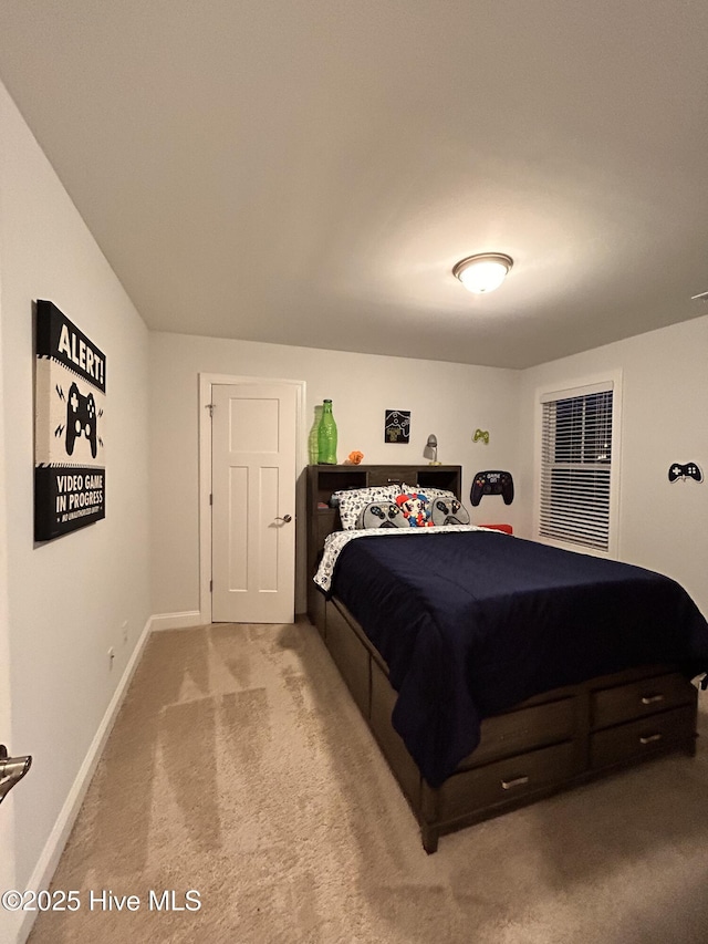 carpeted bedroom featuring baseboards