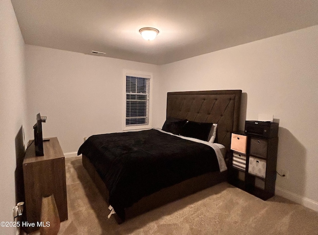 bedroom with carpet floors, visible vents, and baseboards