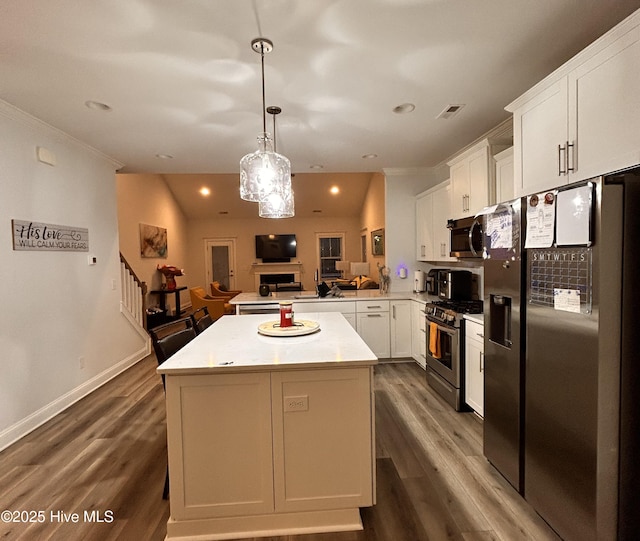 kitchen featuring stainless steel appliances, dark wood-type flooring, visible vents, white cabinetry, and open floor plan