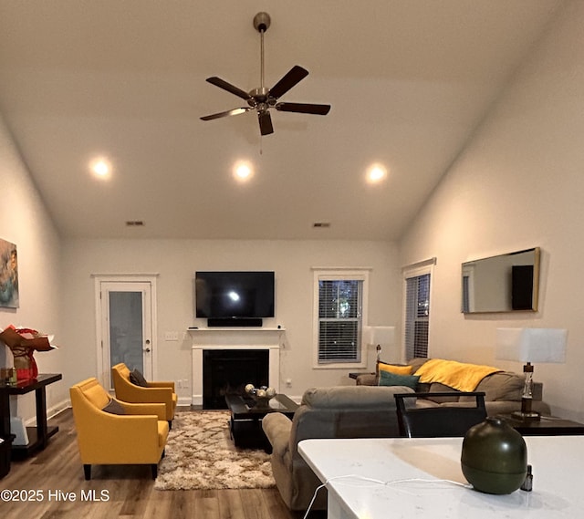 living room featuring a fireplace, dark wood finished floors, ceiling fan, high vaulted ceiling, and baseboards