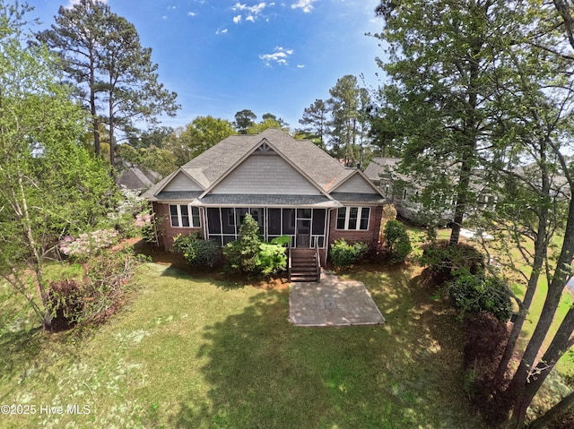 155 Abbington Pl SW, Ocean Isle Beach, NC 28469 - back of property featuring a sunroom, brick siding, a lawn, and a patio