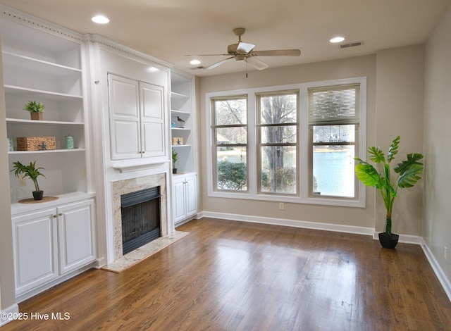 155 Abbington Pl SW, Ocean Isle Beach, NC 28469 - unfurnished living room featuring a ceiling fan, a premium fireplace, plenty of natural light, baseboards, and recessed lighting
