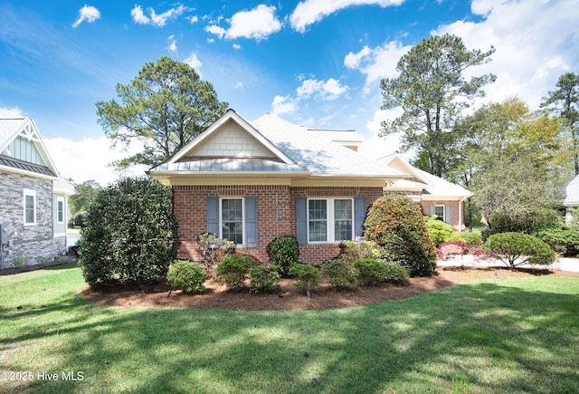 155 Abbington Pl SW, Ocean Isle Beach, NC 28469 - view of front facade featuring brick siding and a front yard