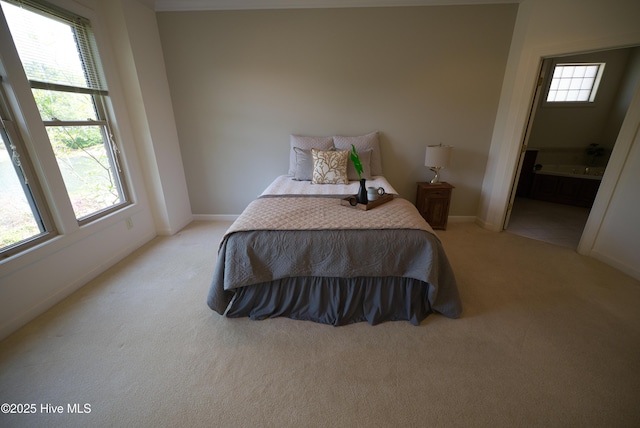 155 Abbington Pl SW, Ocean Isle Beach, NC 28469 - bedroom with light colored carpet, baseboards, and ensuite bathroom