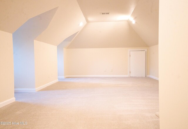 155 Abbington Pl SW, Ocean Isle Beach, NC 28469 - bonus room featuring vaulted ceiling, light carpet, and baseboards