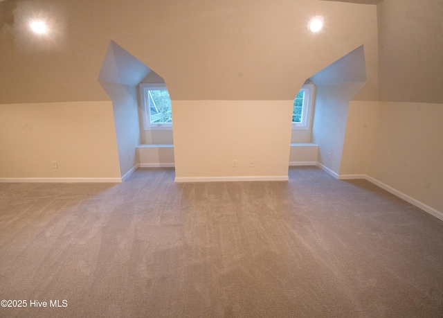 155 Abbington Pl SW, Ocean Isle Beach, NC 28469 - additional living space with vaulted ceiling, carpet flooring, healthy amount of natural light, and baseboards