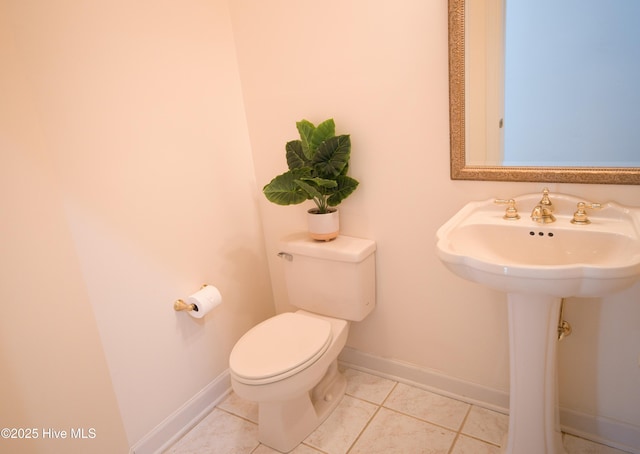 155 Abbington Pl SW, Ocean Isle Beach, NC 28469 - bathroom with baseboards, toilet, tile patterned flooring, and a sink