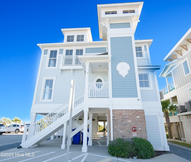 155 Abbington Pl SW, Ocean Isle Beach, NC 28469 - coastal home with stairs, cooling unit, and brick siding