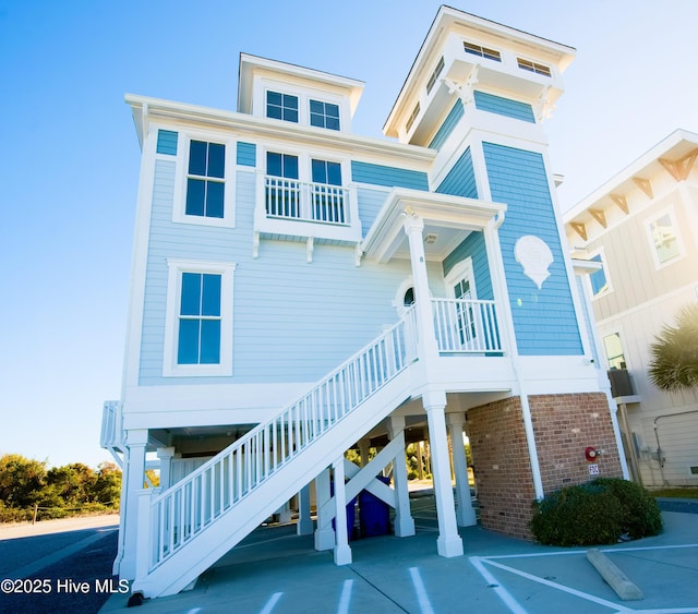 155 Abbington Pl SW, Ocean Isle Beach, NC 28469 - rear view of property with stairs and a carport
