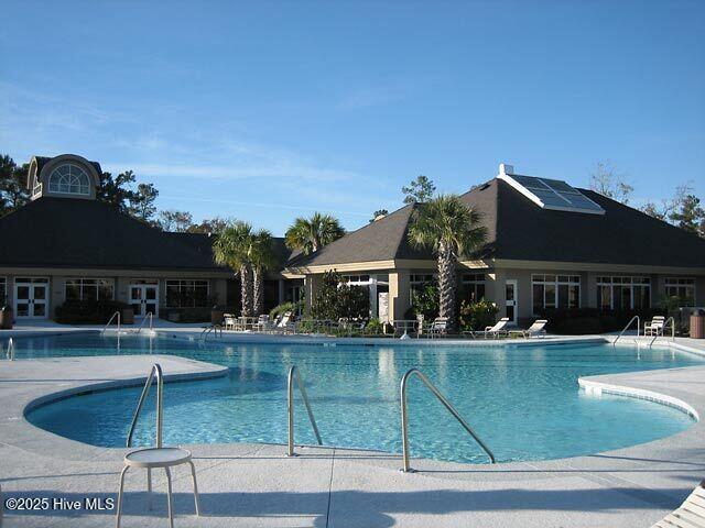 155 Abbington Pl SW, Ocean Isle Beach, NC 28469 - community pool with french doors and a patio