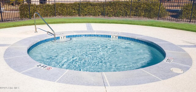 155 Abbington Pl SW, Ocean Isle Beach, NC 28469 - view of swimming pool featuring fence and a hot tub