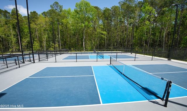 155 Abbington Pl SW, Ocean Isle Beach, NC 28469 - view of tennis court with fence and a view of trees