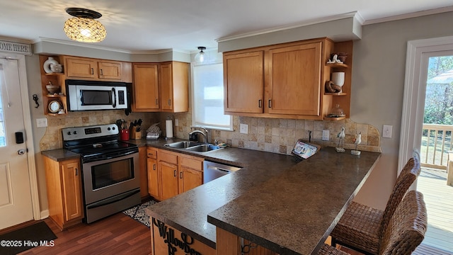 kitchen featuring dark countertops, open shelves, stainless steel appliances, and a sink