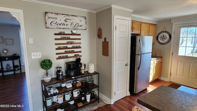 kitchen featuring dark wood-style floors, ornamental molding, freestanding refrigerator, and baseboards