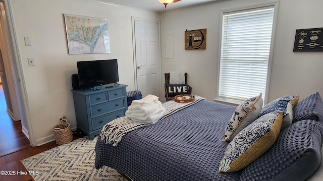 bedroom with baseboards and wood finished floors