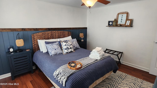 bedroom with baseboards, dark wood finished floors, and a ceiling fan