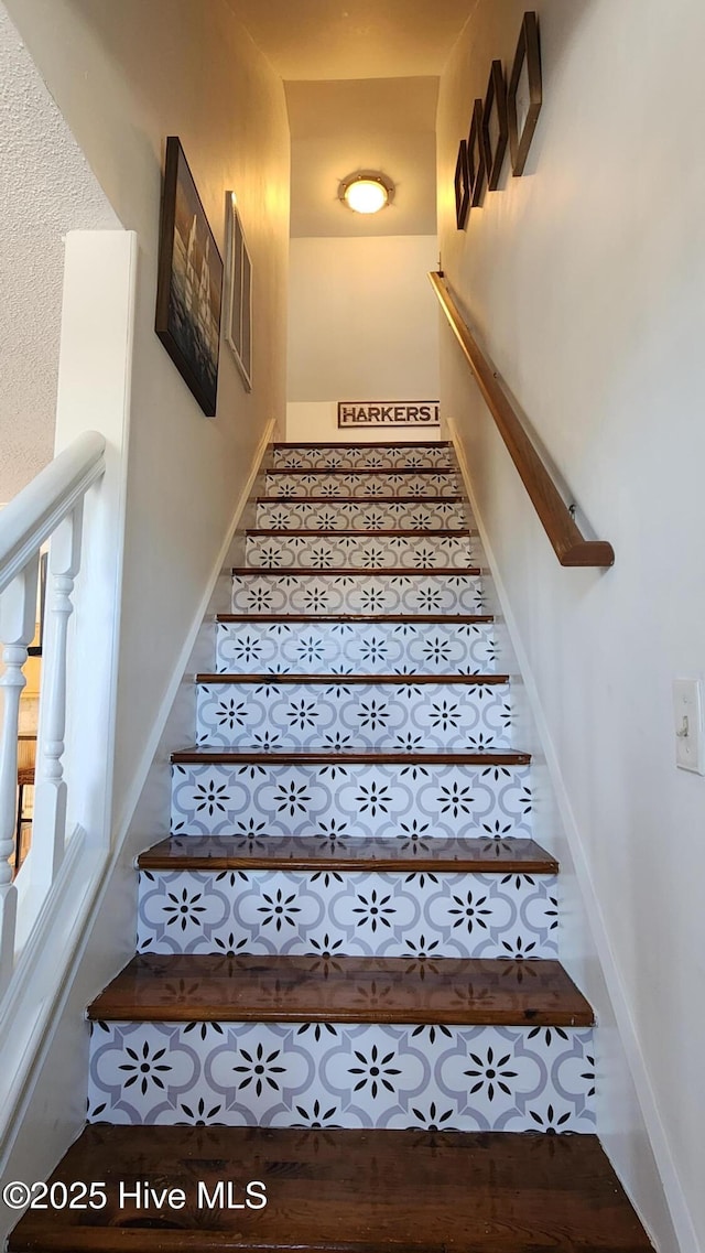 staircase featuring baseboards