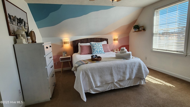 bedroom with lofted ceiling, baseboards, and dark colored carpet