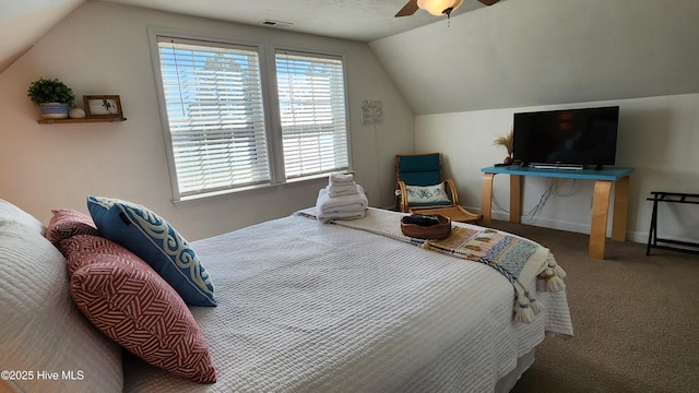 bedroom featuring baseboards, visible vents, a ceiling fan, lofted ceiling, and carpet