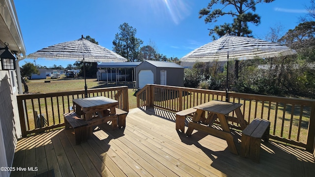 wooden deck featuring a storage unit, a lawn, and an outdoor structure